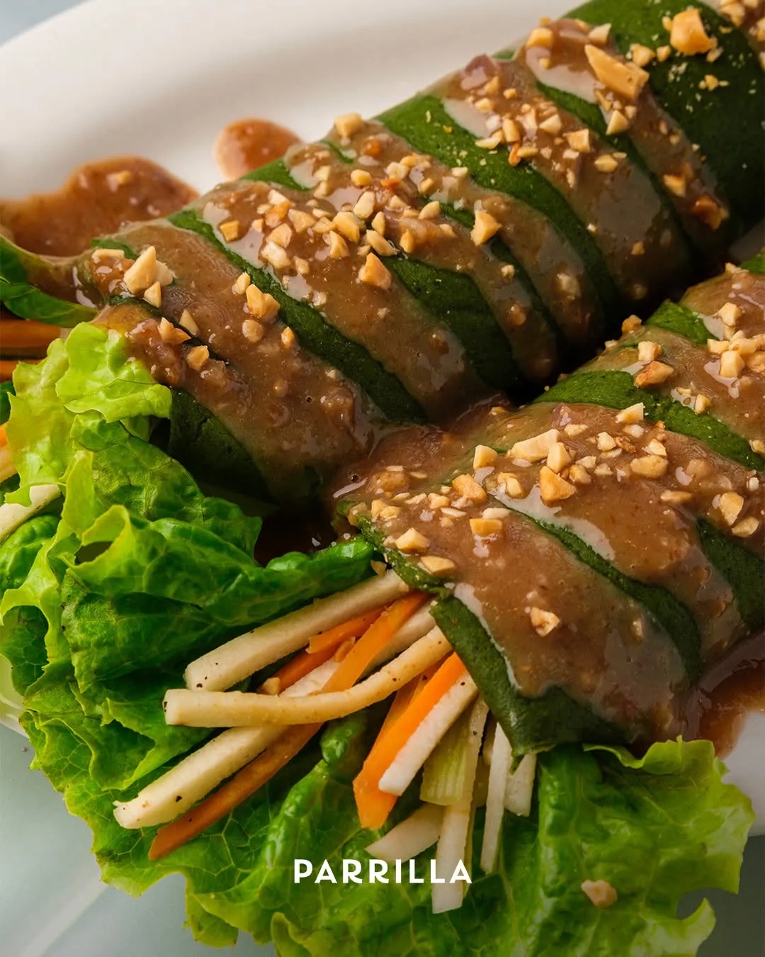 Fresh lumpia in a kangkong wrapper with peanut sauce